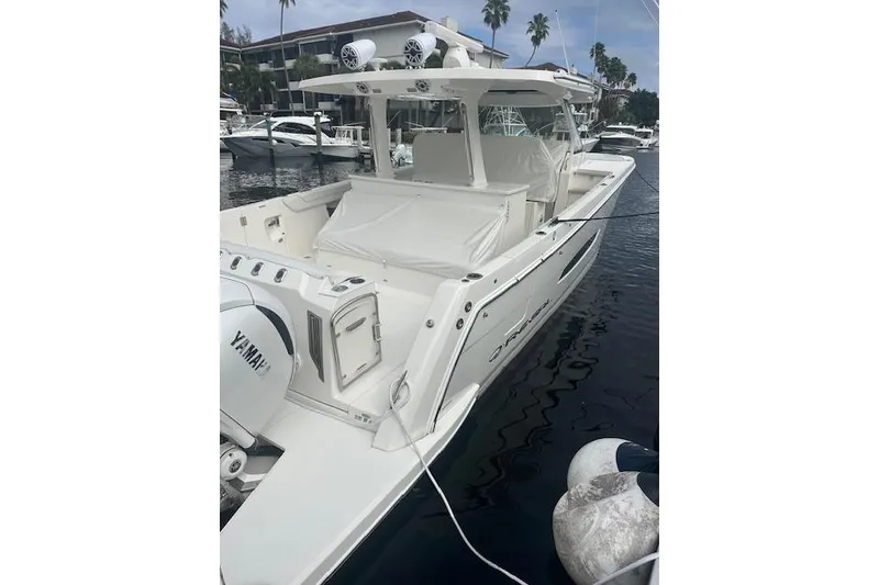 Slide: The Image of 2022 Regal 38 SAV boat docked, featuring Yamaha engines and sleek design. - 41