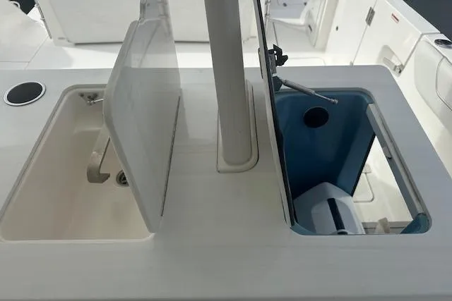 Slide: The Image of 2022 Regal 38 SAV boat storage compartments with open lids. - 47