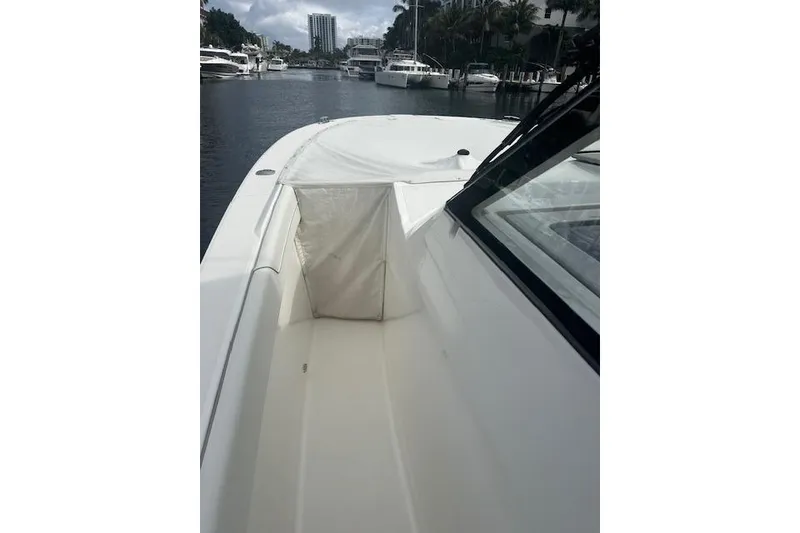 Slide: The Image of 2022 Regal 38 SAV boat deck view in marina setting. - 49