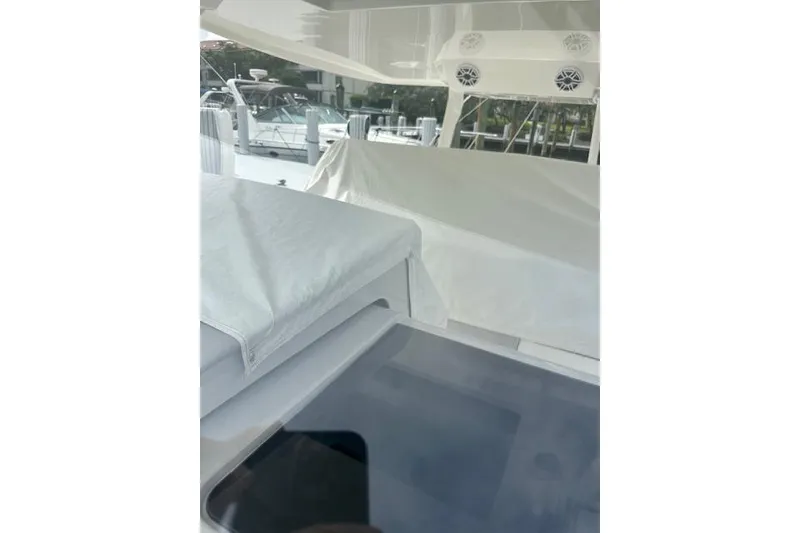 Slide: The Image of 2022 Regal 38 SAV yacht interior with covered seating and modern design. - 50