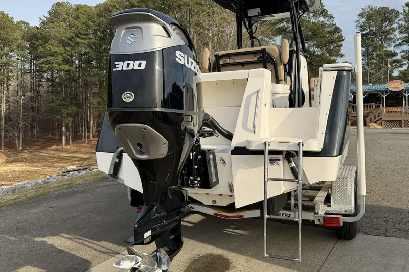 Slide: The Image of 2024 Sea Born SX239 Offshore boat with Suzuki 300 engine on trailer. - 2