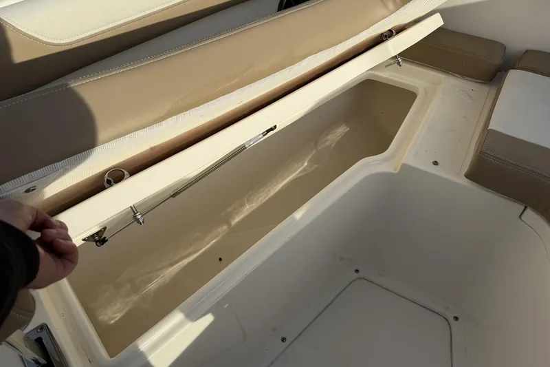 Slide: The Image of 2024 Sea Born SX239 Offshore boat storage compartment with beige seating. - 24