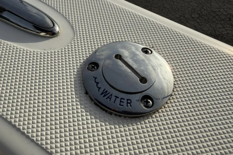 Slide: The Image of 2024 Sea Born SX239 Offshore boat water fill cap on textured surface. - 31