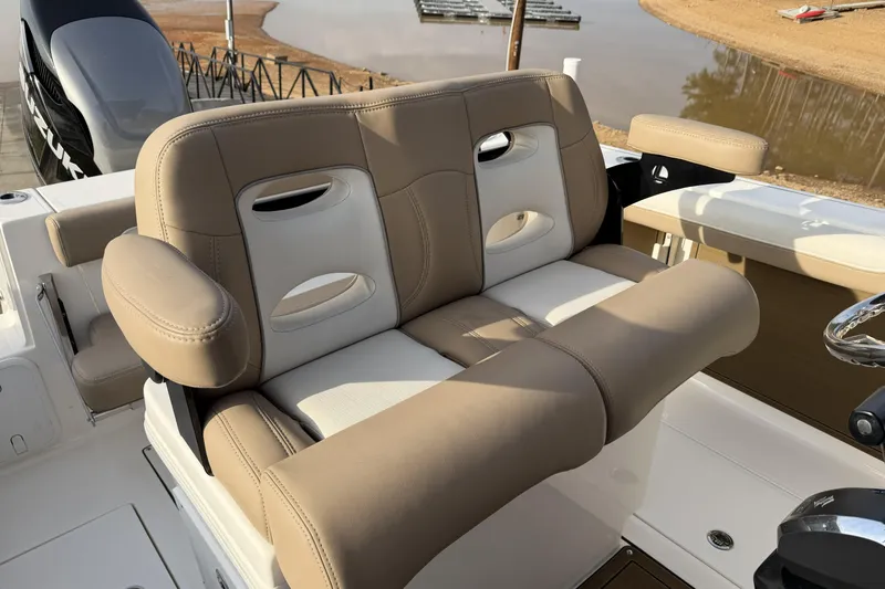 Slide: The Image of 2024 Sea Born SX239 Offshore boat with tan and white cushioned seating. - 8
