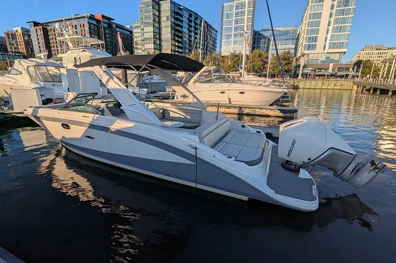The Image of 2021 Sea Ray SDX 270 Outboard boat docked in urban marina setting. - 0