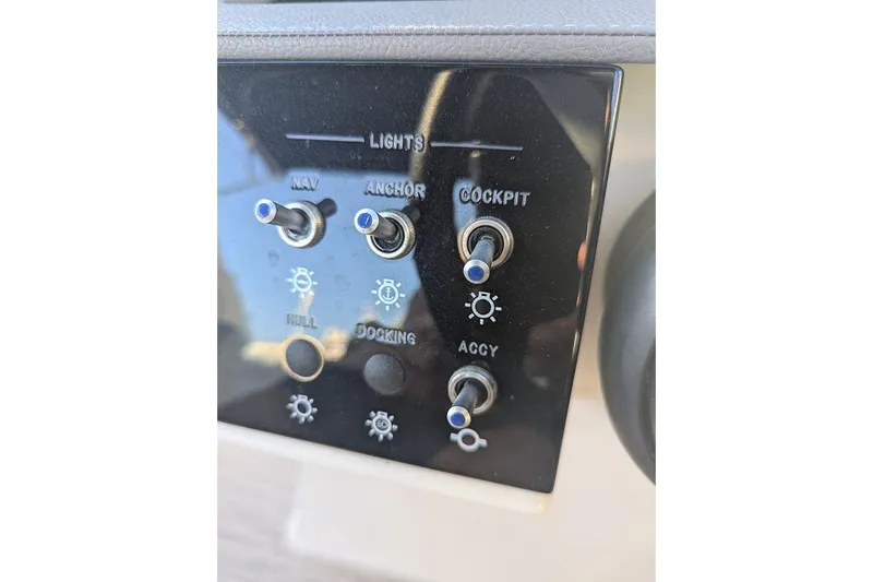 Slide: The Image of Control panel of 2021 Sea Ray SDX 270 Outboard with light switches. - 13