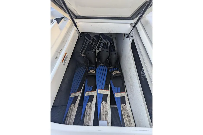 Slide: The Image of Storage compartment with water skis in a 2021 Sea Ray SDX 270 Outboard boat. - 16