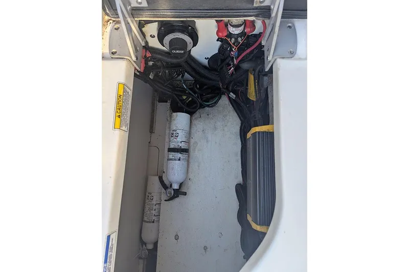 Slide: The Image of 2021 Sea Ray SDX 270 Outboard engine compartment with wiring and fire extinguisher. - 17