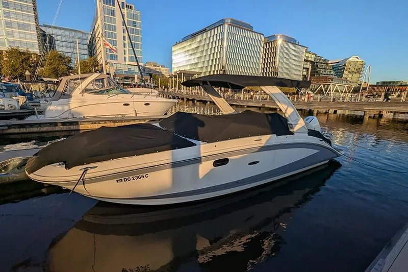 Slide: The Image of 2021 Sea Ray SDX 270 Outboard boat docked in urban marina at sunset. - 2