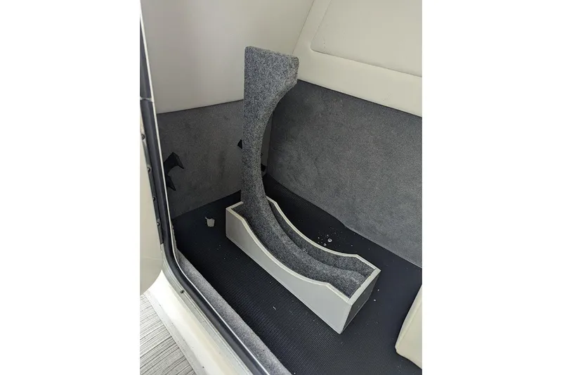 Slide: The Image of 2021 Sea Ray SDX 270 Outboard interior storage compartment with carpeted lining. - 21