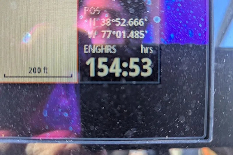 Slide: The Image of Display screen showing coordinates and engine hours on a 2021 Sea Ray SDX 270 Outboard. - 23