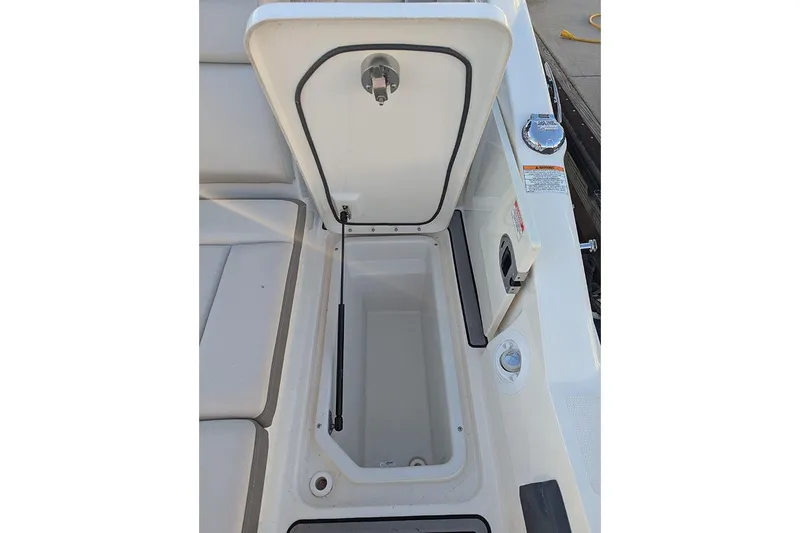 Slide: The Image of 2021 Sea Ray SDX 270 Outboard storage compartment with open hatch, showcasing interior space. - 31