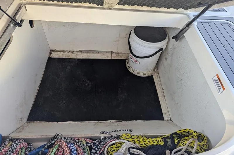 Slide: The Image of 2021 Sea Ray SDX 270 Outboard storage compartment with ropes and a bucket. - 37