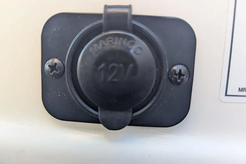 Slide: The Image of 12V marine power outlet on 2021 Sea Ray SDX 270 Outboard boat. - 38