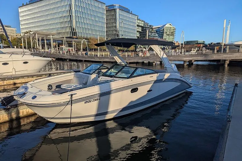 Slide: The Image of 2021 Sea Ray SDX 270 Outboard boat docked in urban marina setting. - 4