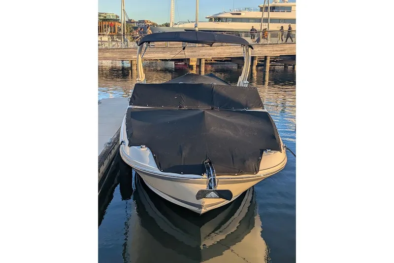 Slide: The Image of 2021 Sea Ray SDX 270 Outboard boat docked with cover on, in a marina setting. - 6