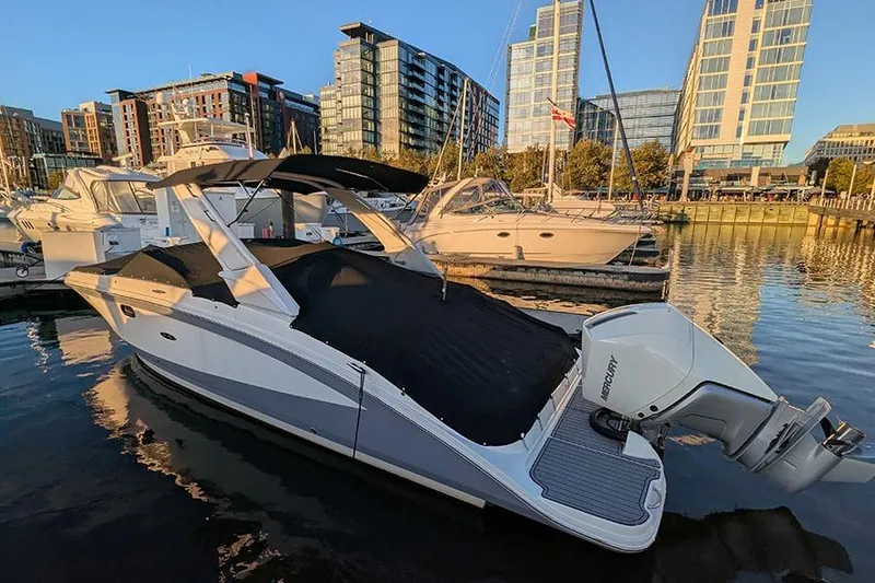 Slide: The Image of 2021 Sea Ray SDX 270 Outboard docked in urban marina at sunset. - 8