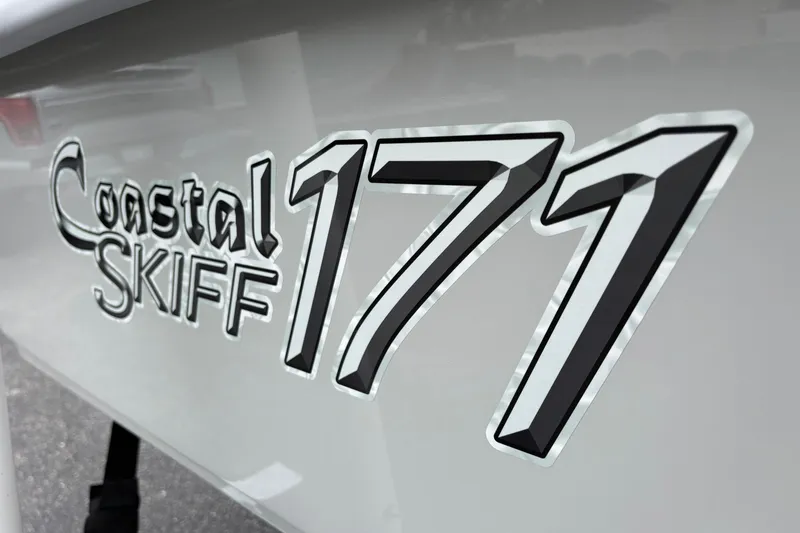 Slide: The Image of Coastal Skiff 171 boat logo, 2026 model, sleek design on hull. - 17