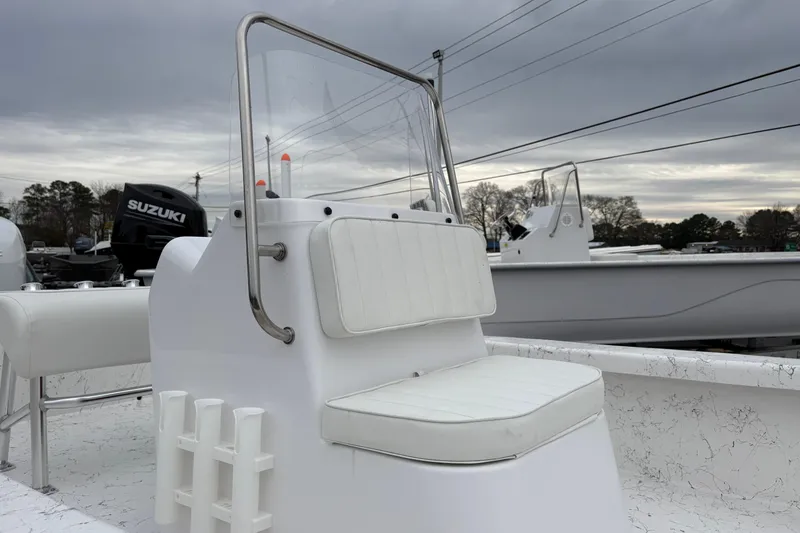 Slide: The Image of 2026 Coastal Skiff 171 boat with white seating and Suzuki outboard motor. - 5