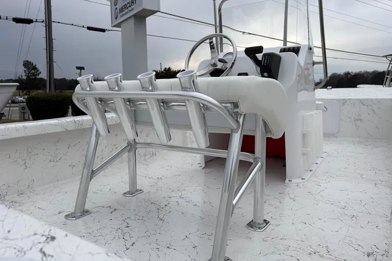 Slide: The Image of 2026 Coastal Skiff 171 boat interior with steering console and rod holders. - 8
