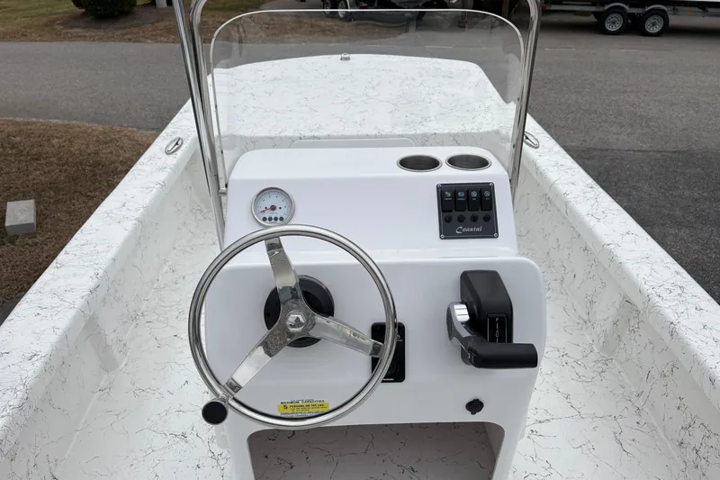 Slide: The Image of 2026 Coastal Skiff 171 boat console with steering wheel and controls. - 9