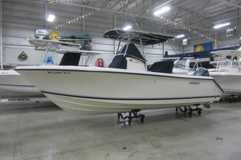 The Image of 2011 Pursuit C 230 Center Console boat displayed indoors. - 0