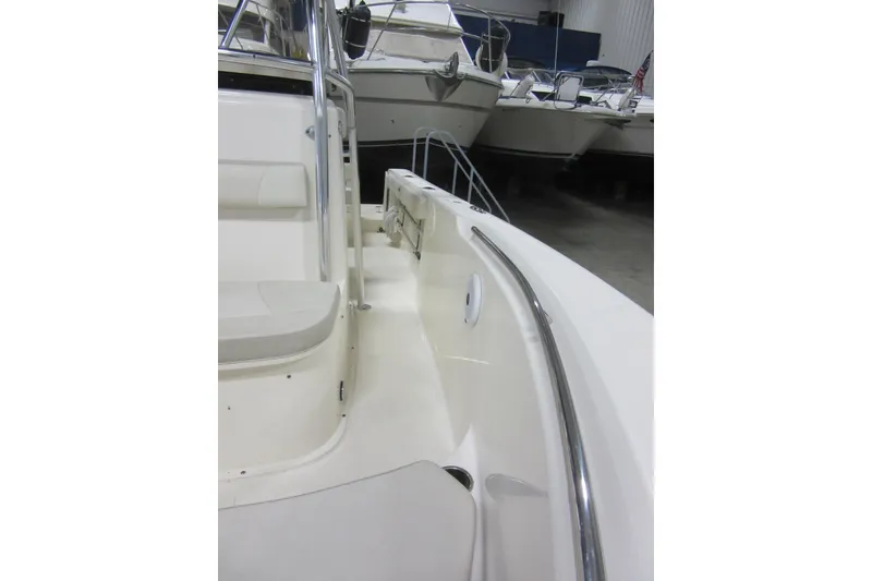Slide: The Image of 2011 Pursuit C 230 Center Console boat interior with seating and railing. - 11