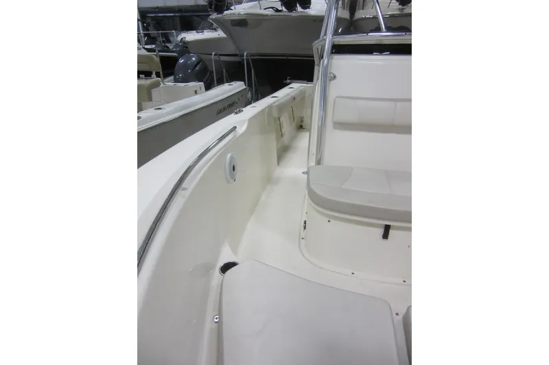 Slide: The Image of 2011 Pursuit C 230 Center Console boat interior with seating and console view. - 13