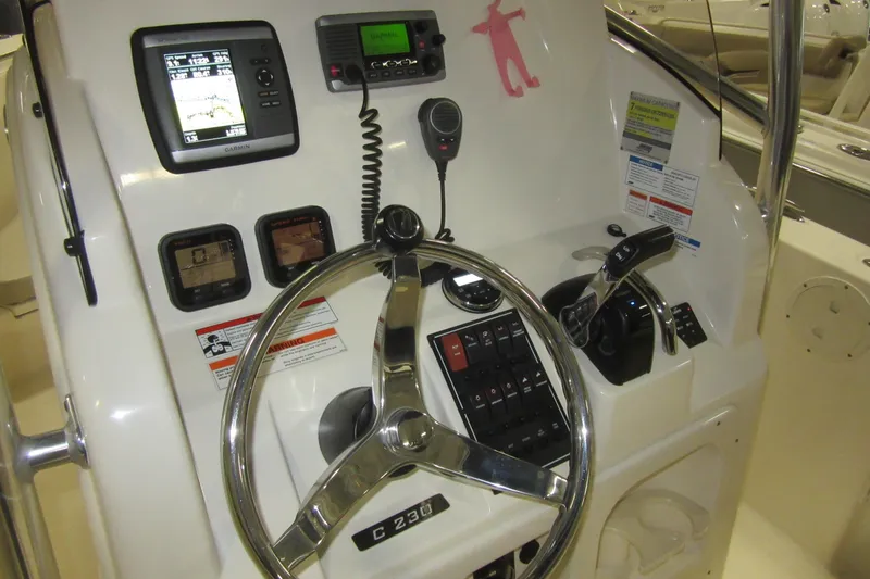 Slide: The Image of 2011 Pursuit C 230 Center Console dashboard with steering wheel and navigation controls. - 15