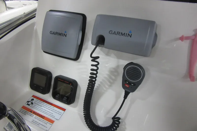 Slide: The Image of 2011 Pursuit C 230 Center Console with Garmin marine electronics and communication devices. - 16