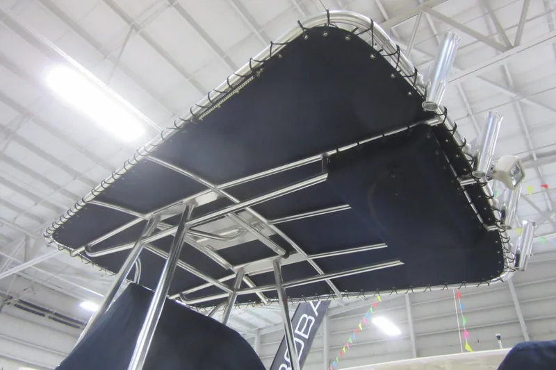 Slide: The Image of 2011 Pursuit C 230 Center Console boat with T-top in a showroom. - 17