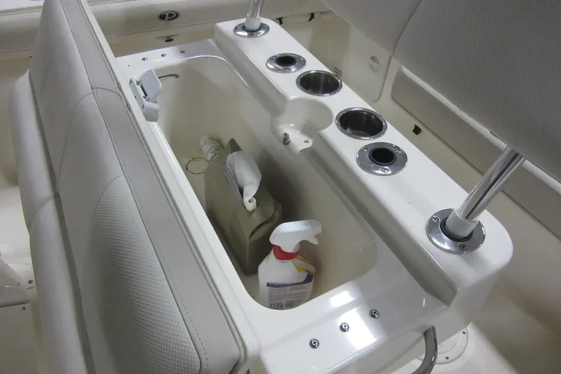 Slide: The Image of 2011 Pursuit C 230 Center Console boat interior with storage and cup holders. - 20