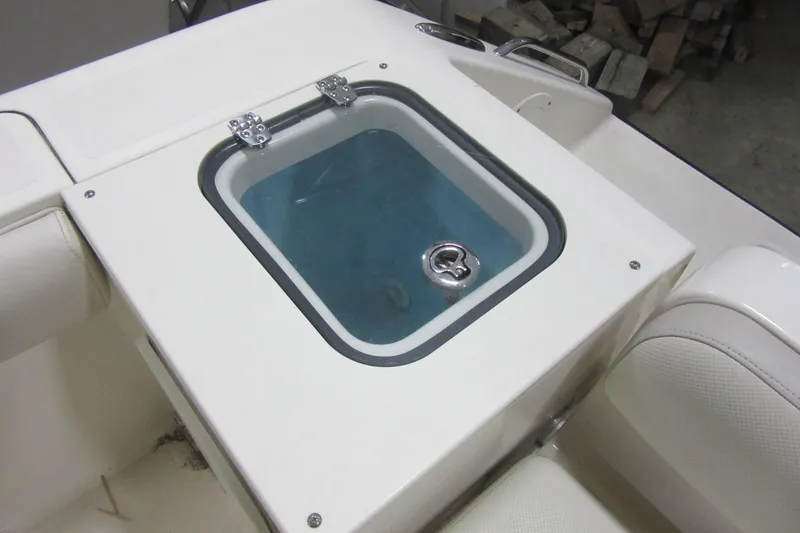 Slide: The Image of Livewell on 2011 Pursuit C 230 Center Console boat, featuring a clear lid and water inside. - 23