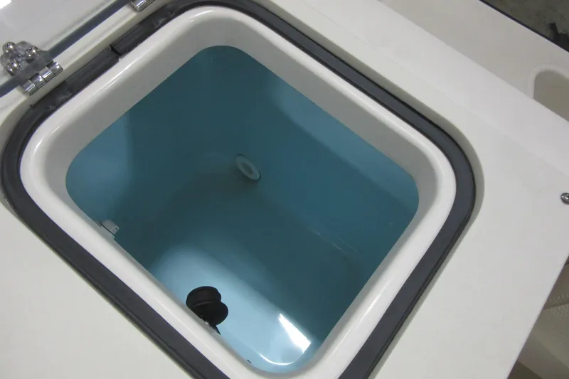 Slide: The Image of Livewell compartment on a 2011 Pursuit C 230 Center Console boat. - 24