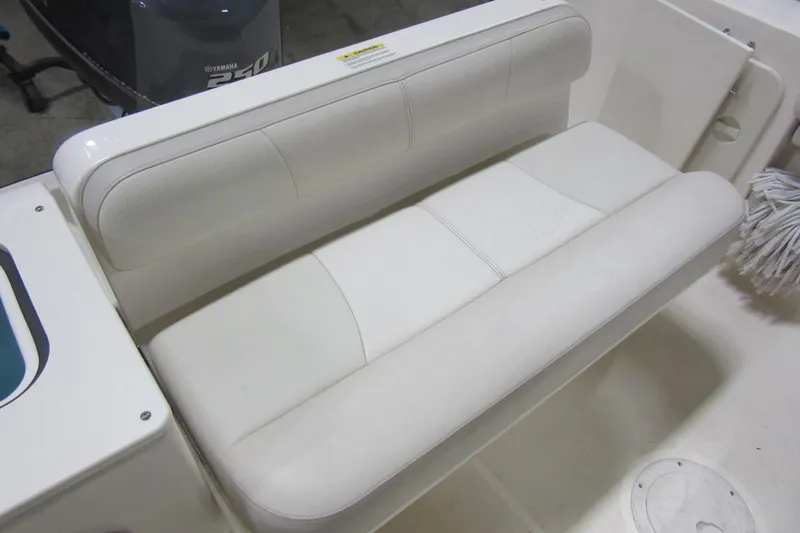 Slide: The Image of 2011 Pursuit C 230 Center Console boat seat with white upholstery. - 25
