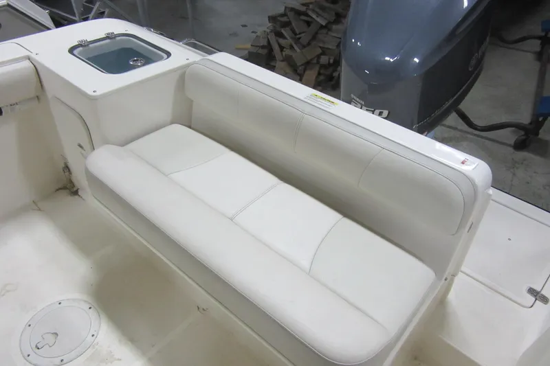 Slide: The Image of 2011 Pursuit C 230 Center Console boat with white cushioned seating and Yamaha engine. - 26
