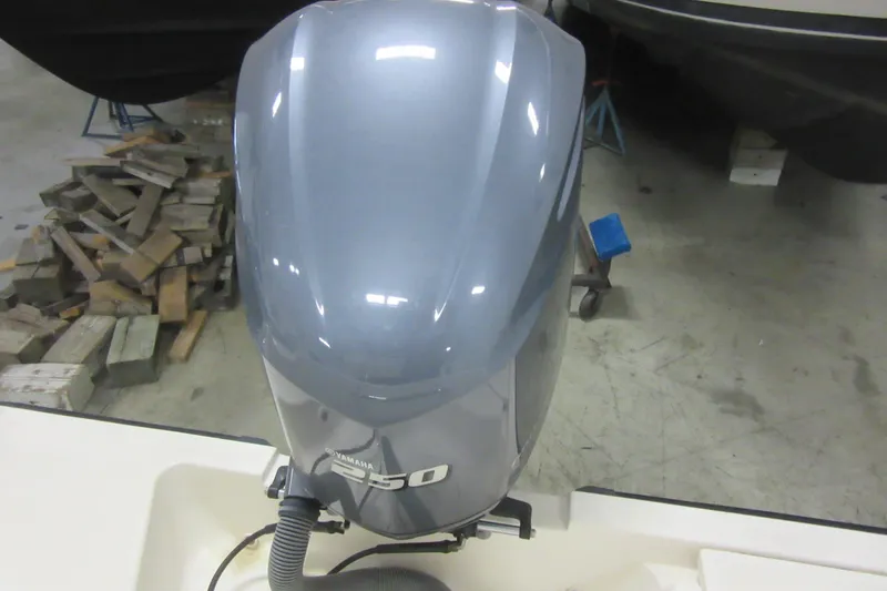 Slide: The Image of Yamaha 250 outboard motor on 2011 Pursuit C 230 Center Console boat in garage. - 31
