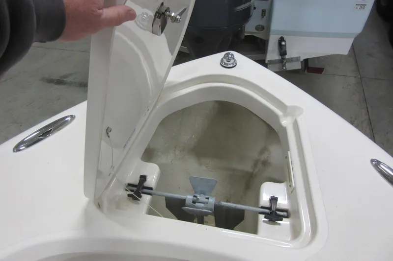 Slide: The Image of Open anchor compartment on 2011 Pursuit C 230 Center Console boat. - 4