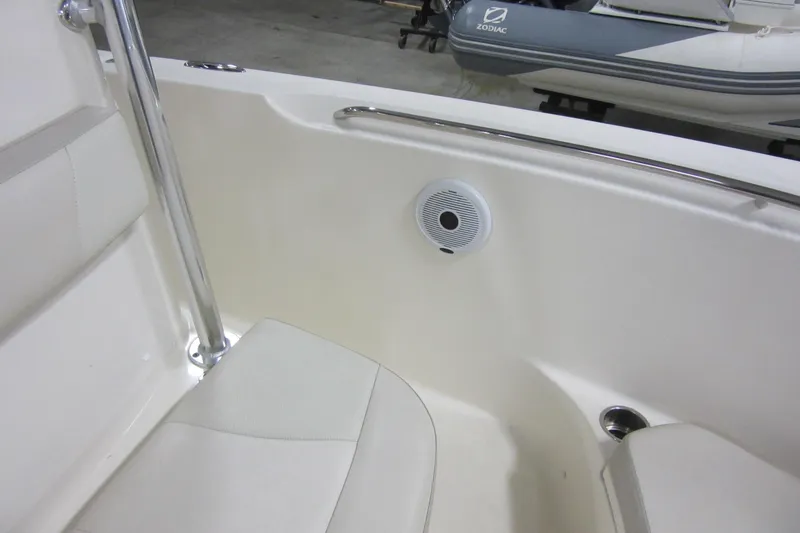 Slide: The Image of 2011 Pursuit C 230 Center Console boat interior with speaker and seating. - 7