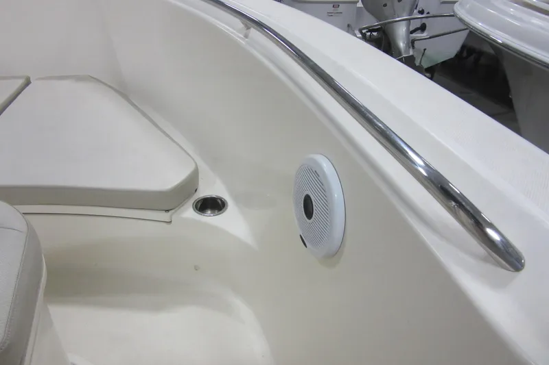 Slide: The Image of 2011 Pursuit C 230 Center Console boat interior with cushioned seating and speaker. - 9