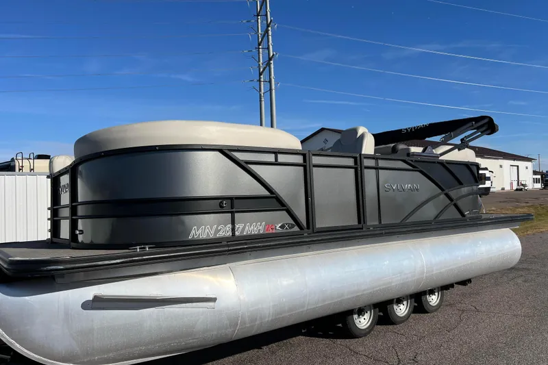 The Image of 2022 Sylvan Mirage X1 Tritoon boat parked outdoors under clear blue sky. - 0