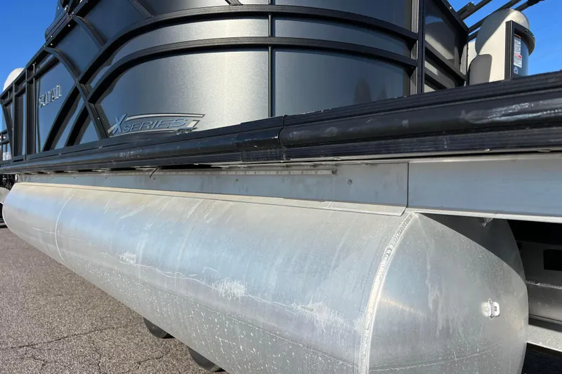 Slide: The Image of 2022 Sylvan Mirage X1 Tritoon pontoon boat, close-up of aluminum hull and side panel. - 10