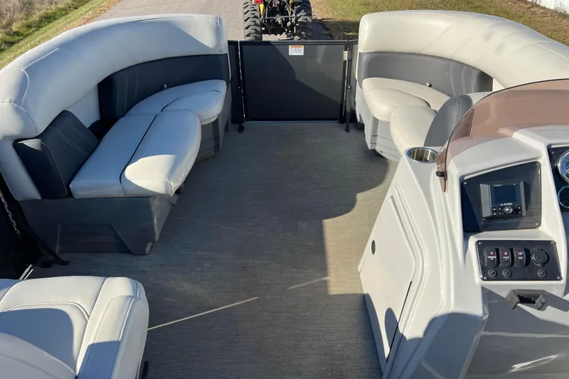 Slide: The Image of Interior of 2022 Sylvan Mirage X1 Tritoon with plush seating and modern dashboard. - 16