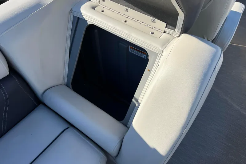 Slide: The Image of 2022 Sylvan Mirage X1 Tritoon seat storage compartment, open and empty. - 27
