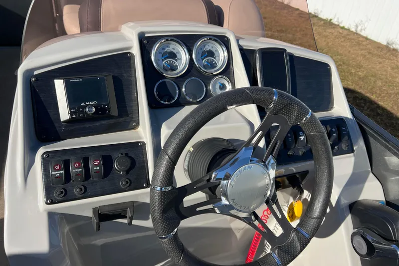 Slide: The Image of Steering console of 2022 Sylvan Mirage X1 Tritoon with gauges and controls. - 30