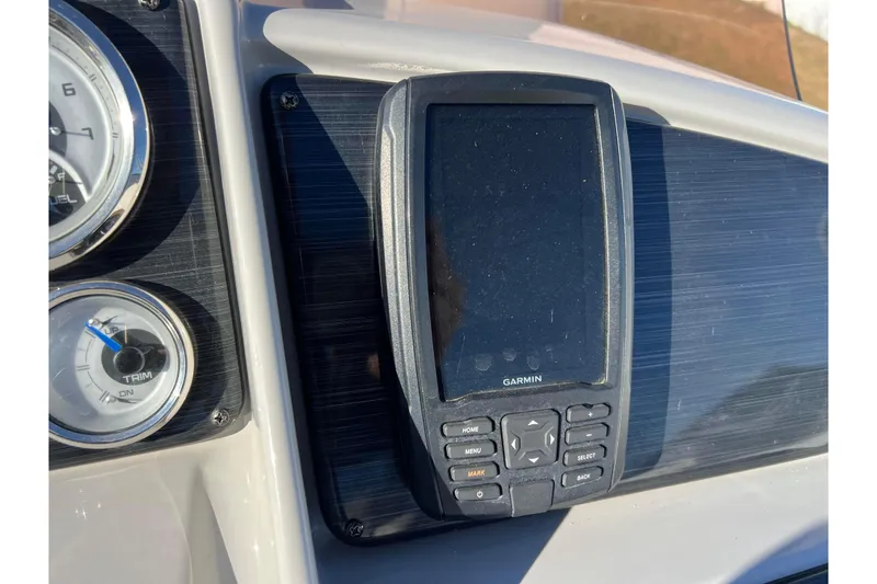 Slide: The Image of Garmin device on 2022 Sylvan Mirage X1 Tritoon dashboard with gauges. - 32