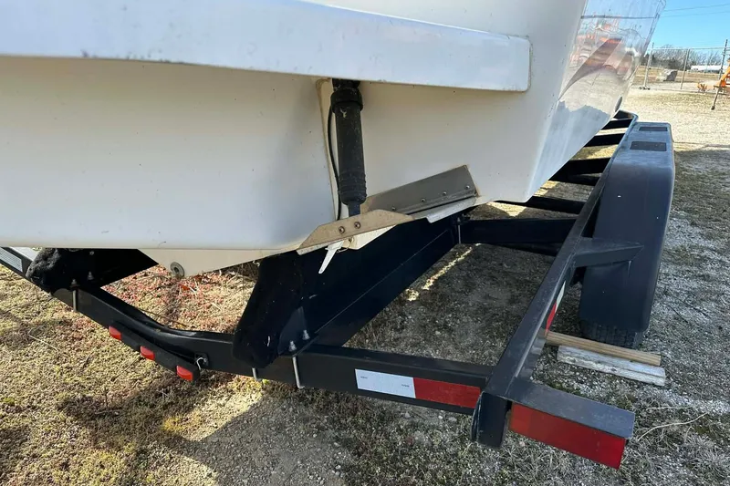 Slide: The Image of 1995 Wellcraft 302 Scarab Sport boat on trailer, showing hull and trim tab. - 11