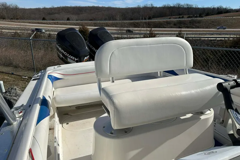 Slide: The Image of 1995 Wellcraft 302 Scarab Sport boat with dual Mercury engines and white seating. - 17