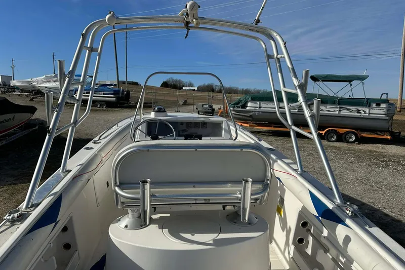 Slide: The Image of 1995 Wellcraft 302 Scarab Sport boat with open cockpit and metal framework. - 18