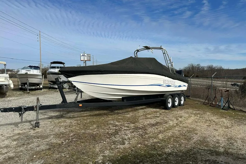 Slide: The Image of 1995 Wellcraft 302 Scarab Sport boat on trailer, covered, parked outdoors. - 21